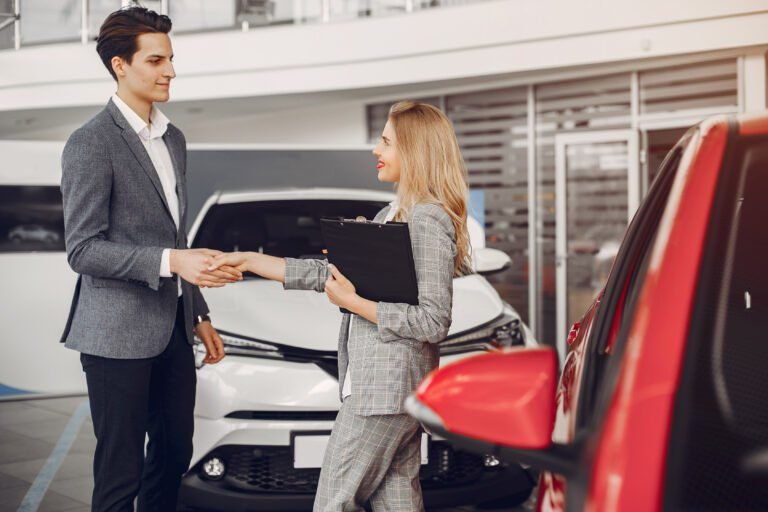 Two stylish woman in a car salon
